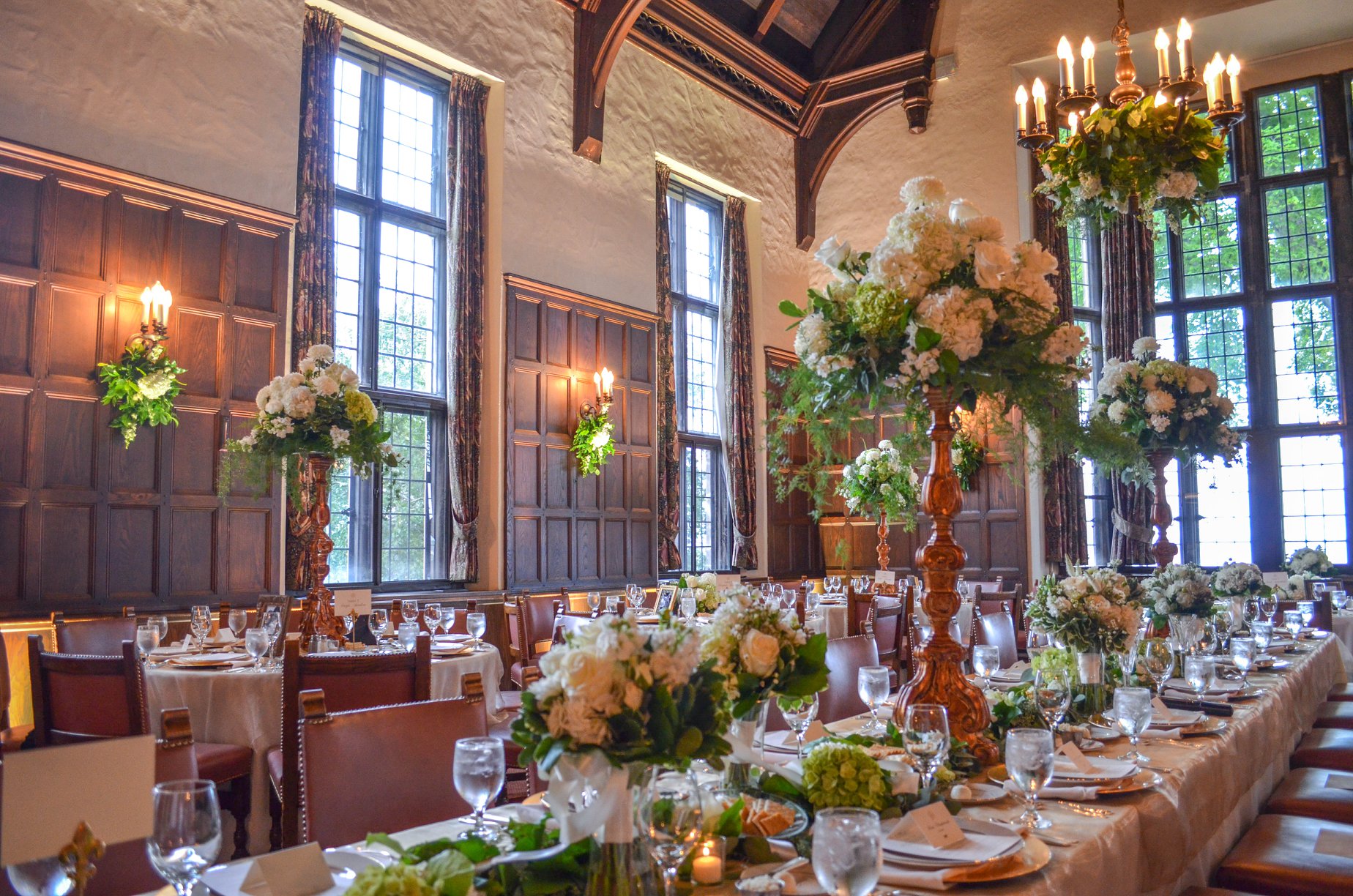 Grand room tables setup for dining adorned with flowers