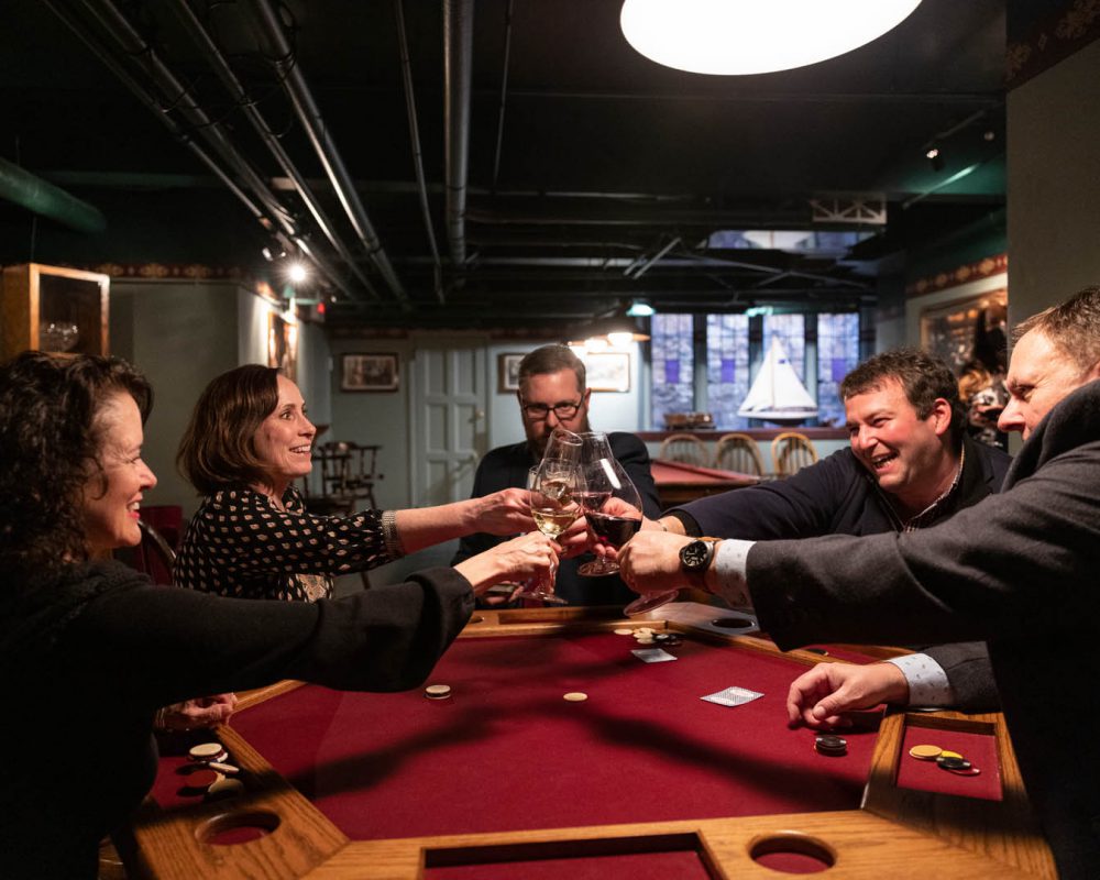 group of people toasting while gambling