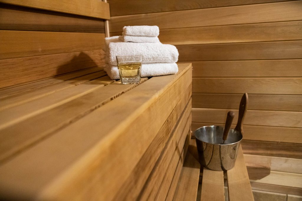 sauna with a drink and towels